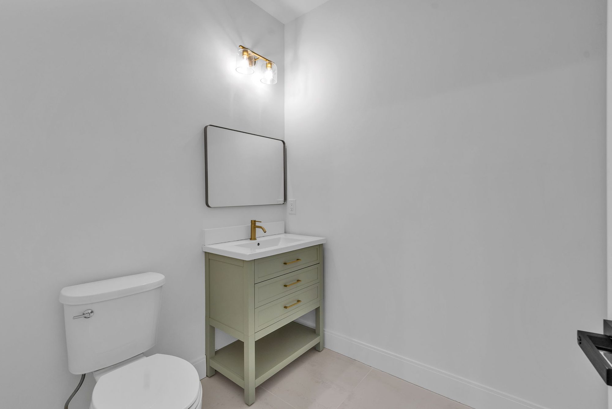 Powder room with sage green vanity