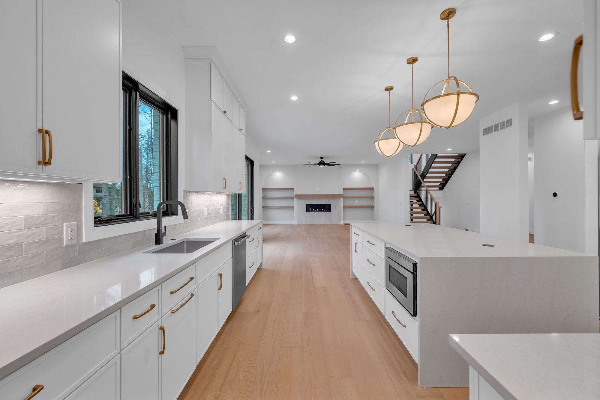 Sink run with quartz counters open to living room