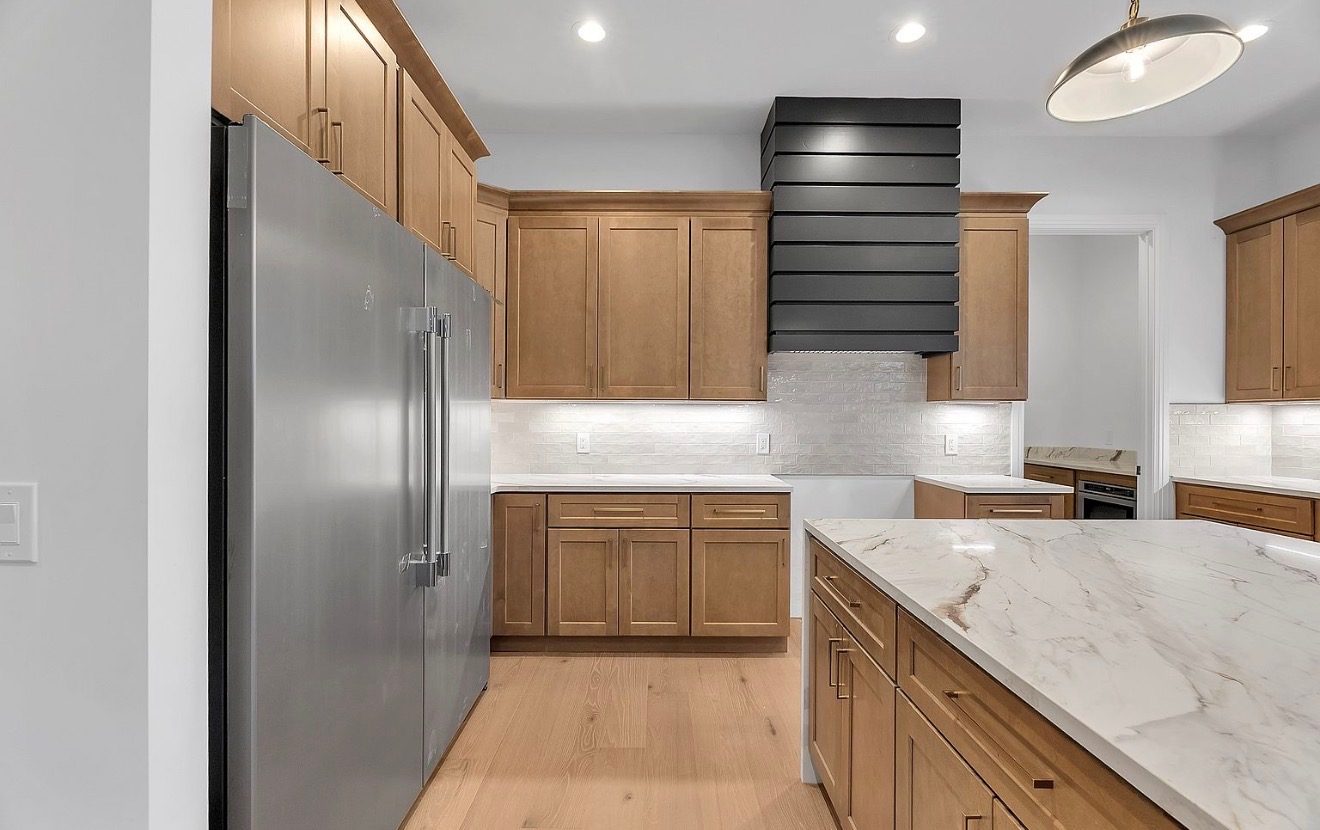 Maple cabinets with a black slatted range hood