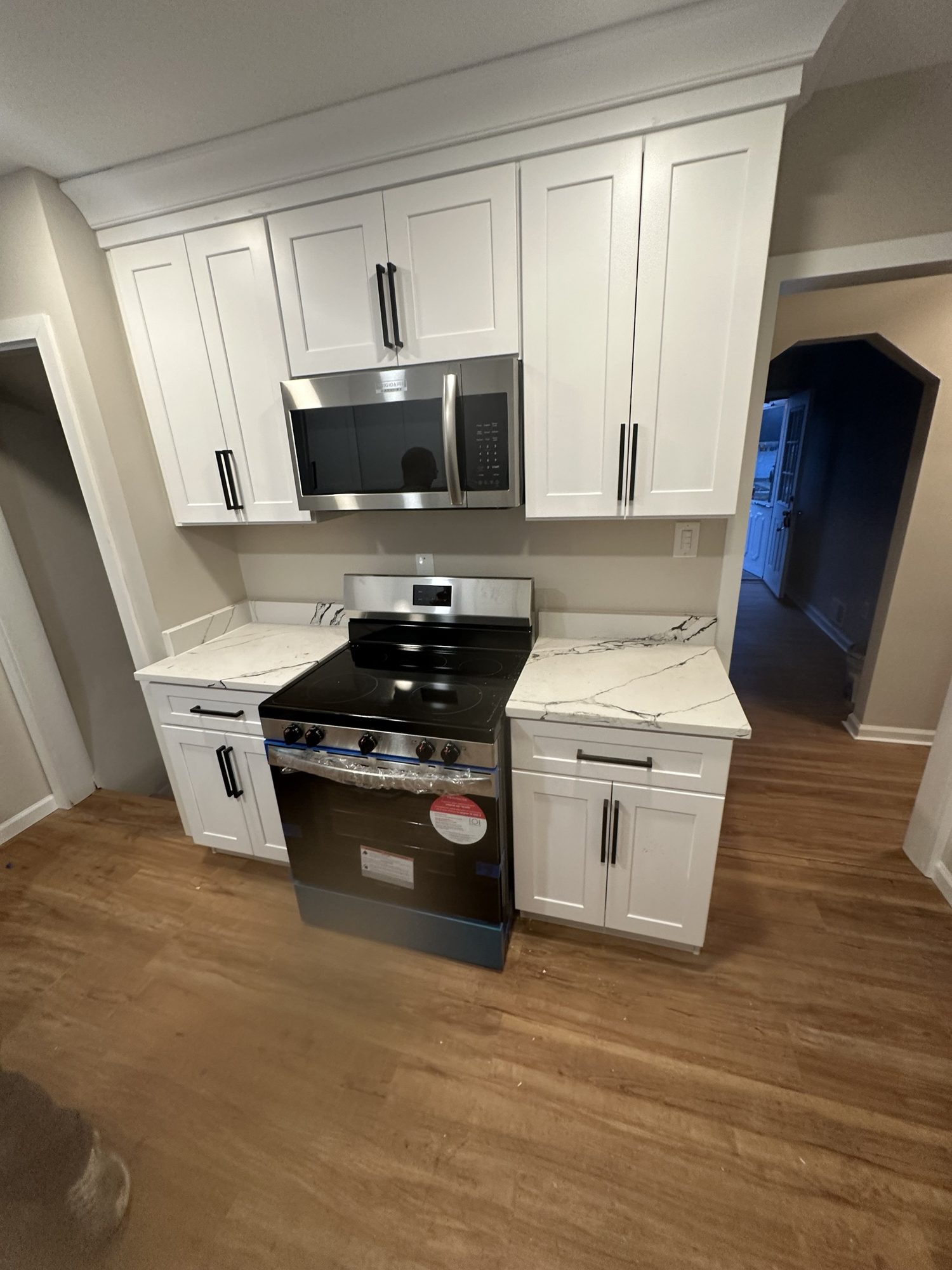 Compact white shaker kitchen with calacatta quartz