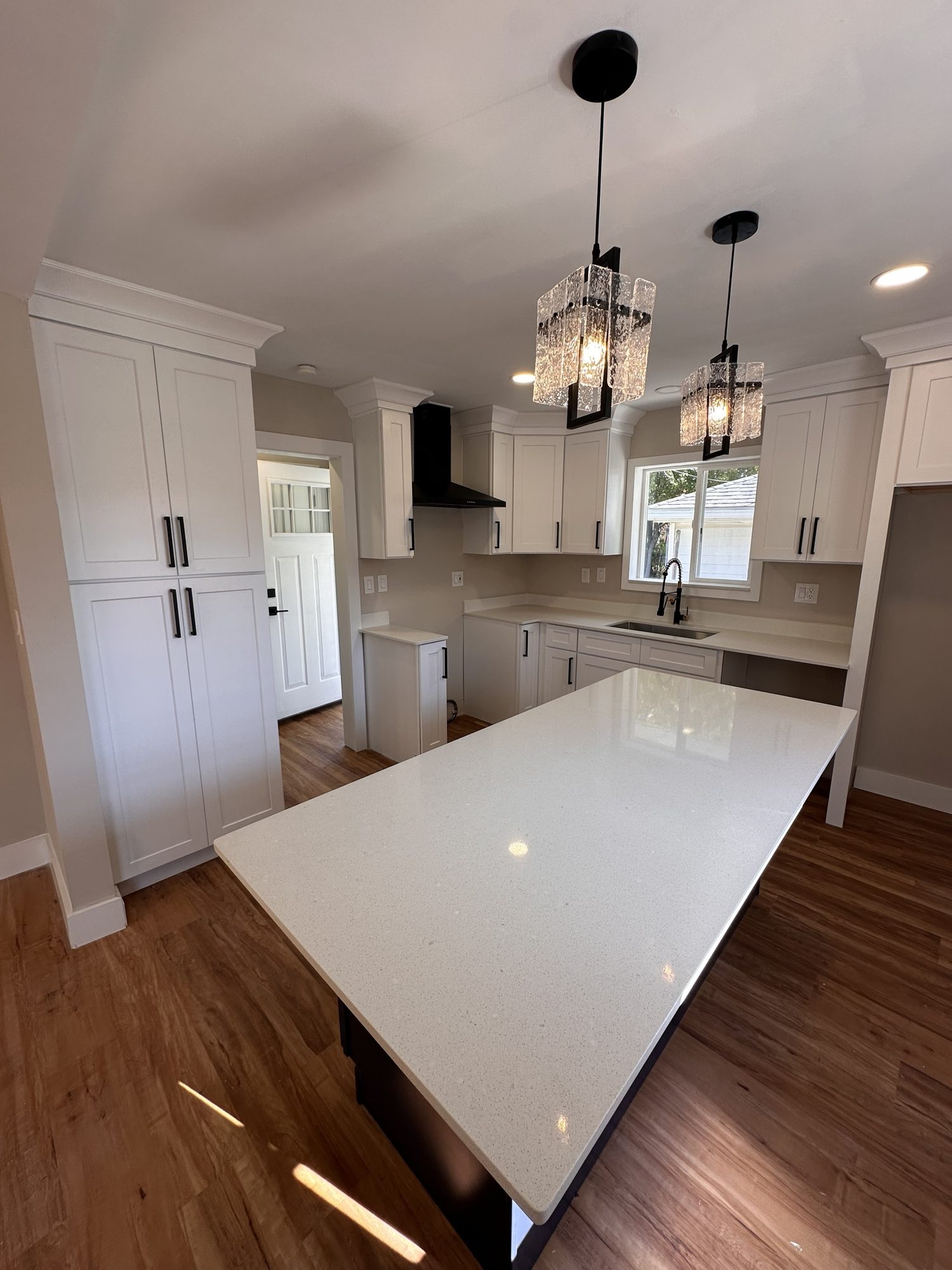 Crystal pendants over a white quartz island
